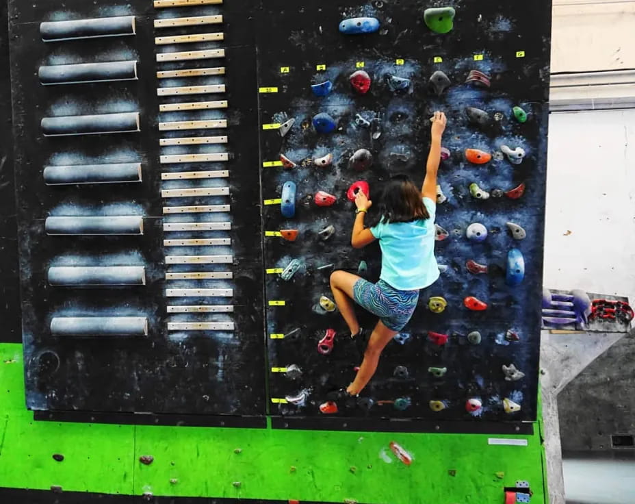 a girl climbing a wall