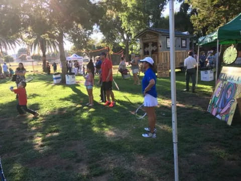 a group of people playing tennis