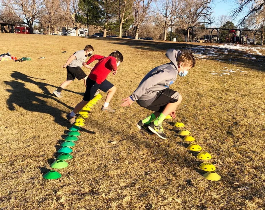 a group of kids playing in a field