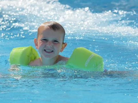 a boy in the water with a surfboard