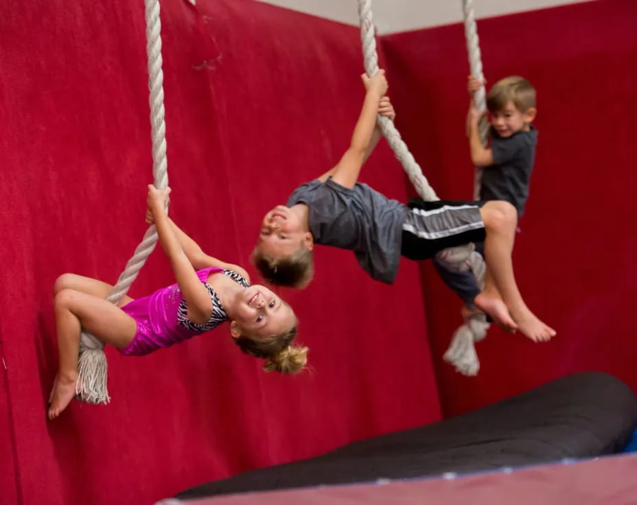 a man and a woman on a swing