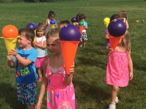 a group of children holding balloons