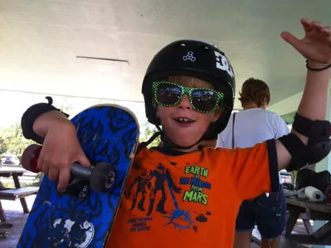 a kid holding a skateboard