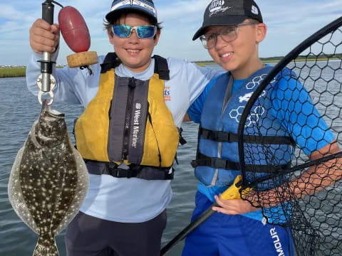 a couple of men holding fish