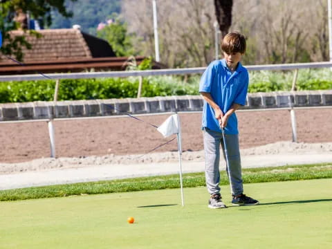 a boy playing golf
