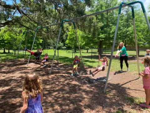 children playing on a swing set