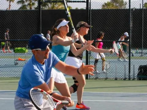 a group of people playing tennis