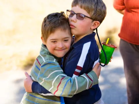 a couple of boys holding a toy