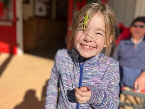 a young girl smiling