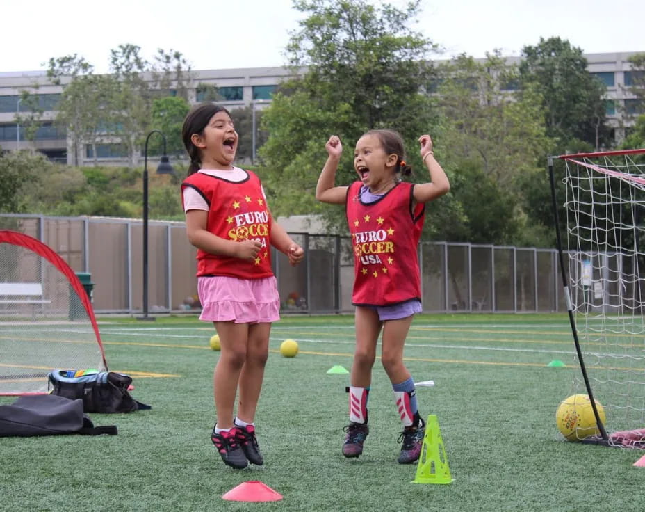 girls playing football on a field