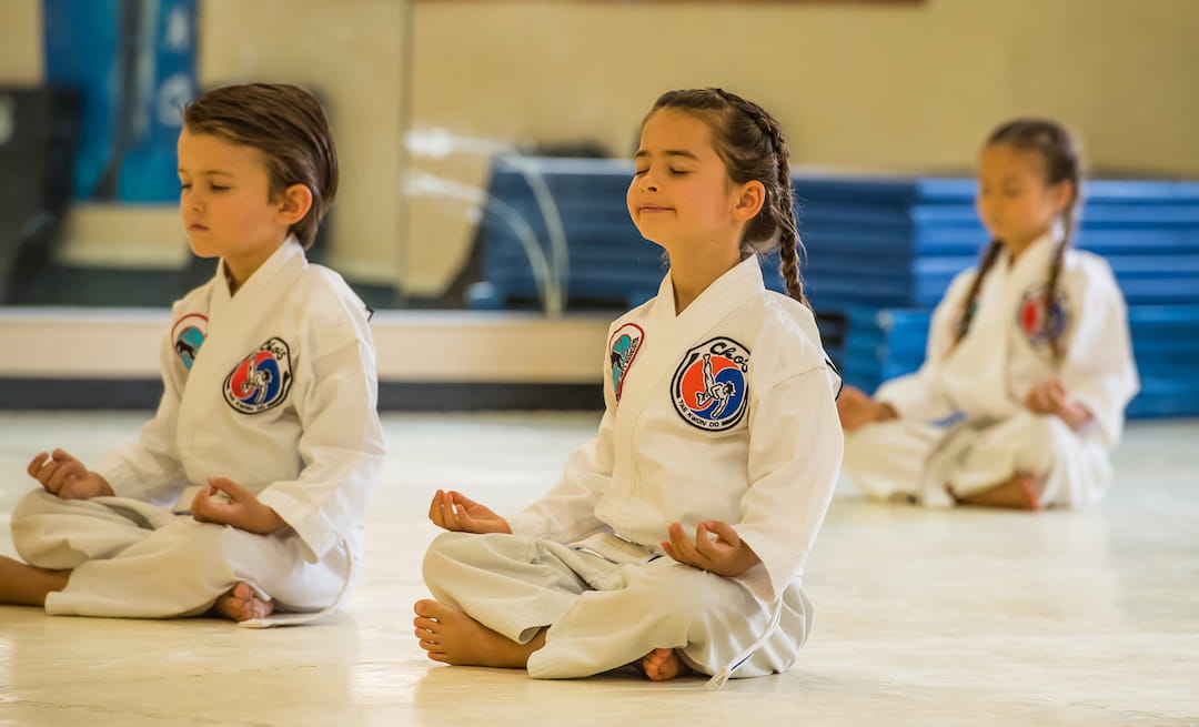 a group of children in karate uniforms