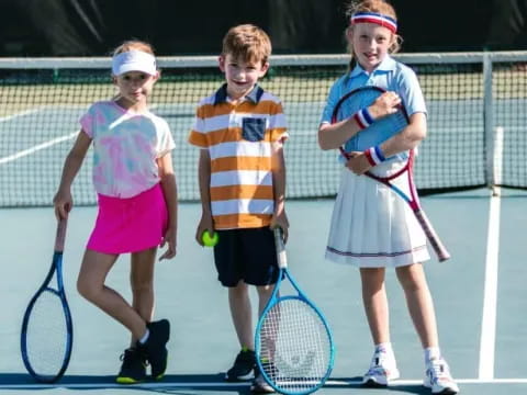 kids holding tennis rackets
