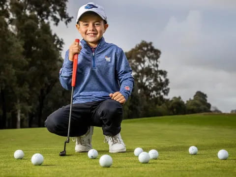 a boy playing golf