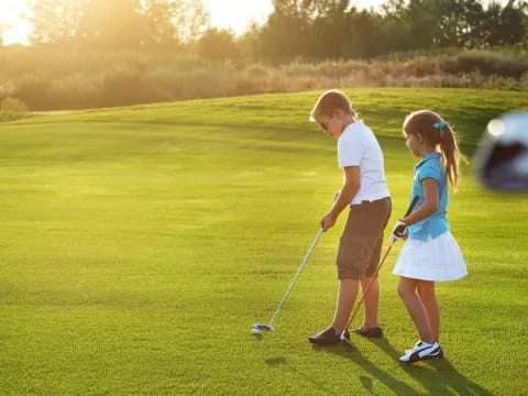 a man and a woman playing golf