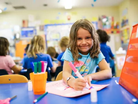 a girl sitting at a table