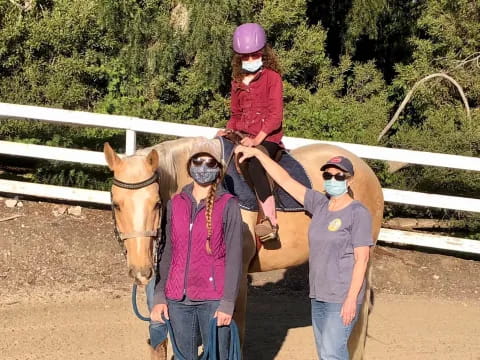 a group of people with a horse