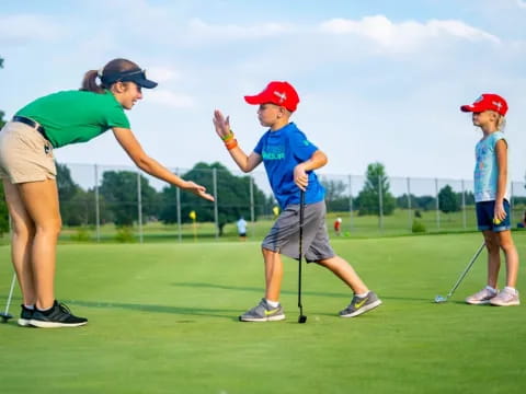 a person and a boy playing golf