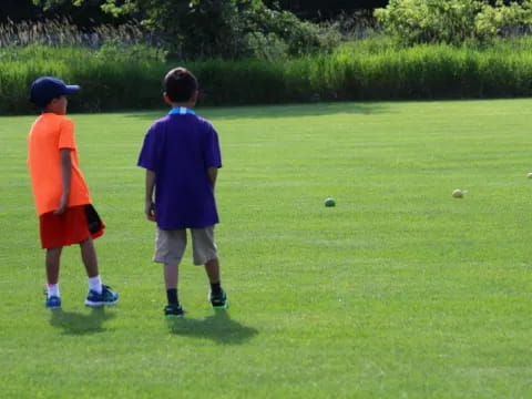 two boys playing with balls