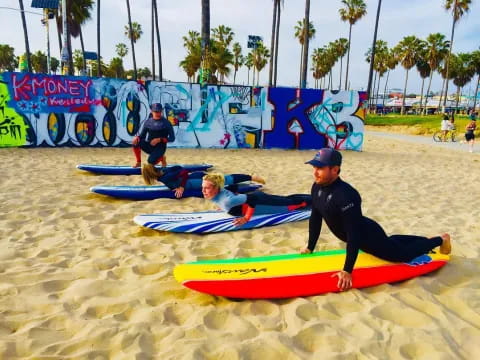 a group of surfers on the beach