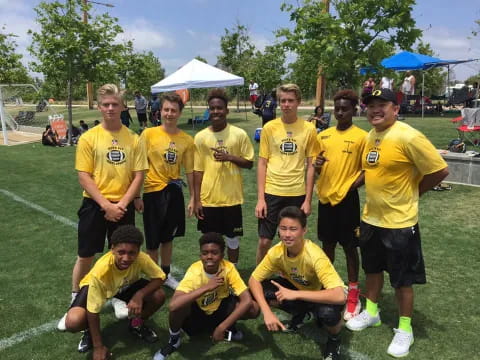 a group of men in yellow shirts