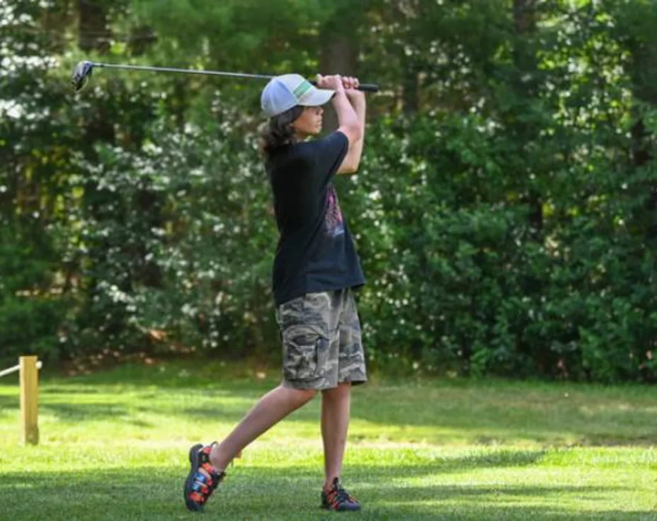 a person swinging a golf club