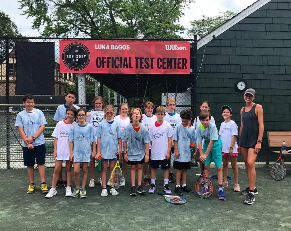 a group of people posing for a photo with tennis rackets