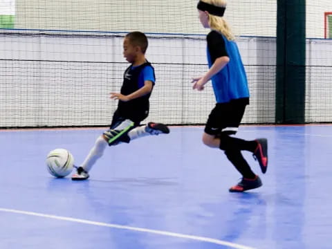 a man and a boy playing football
