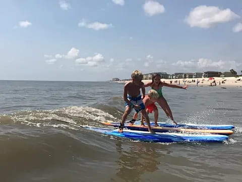 kids on a surfboard in the ocean