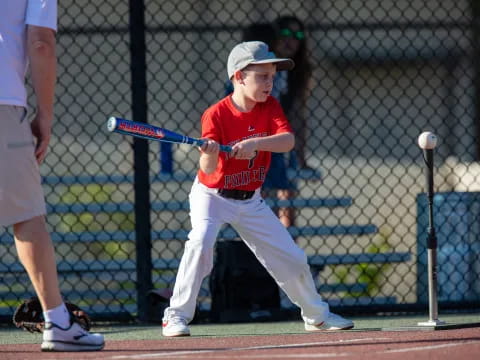 a boy swinging a baseball bat