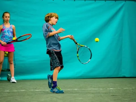 a boy playing tennis