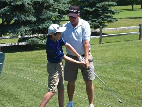 a man and a boy playing golf