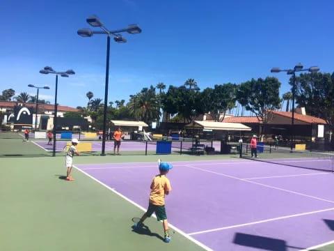 a group of people play tennis