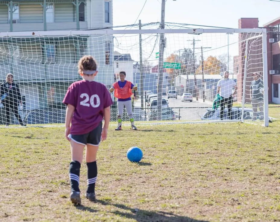a group of kids playing football