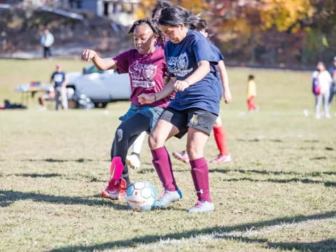 girls playing football on a field