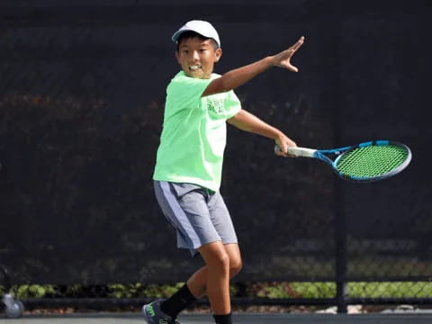 a boy playing tennis