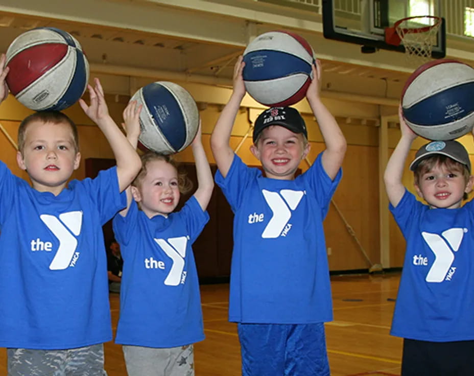 a group of kids holding balls