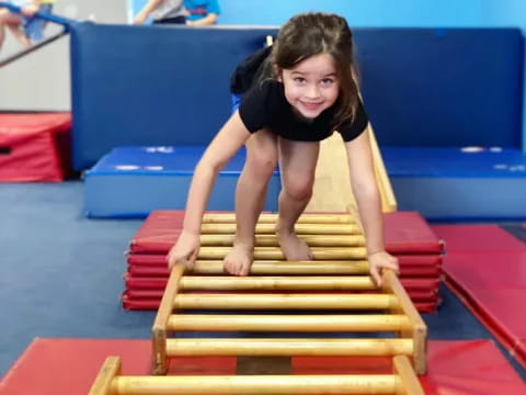 a girl on a stack of wood