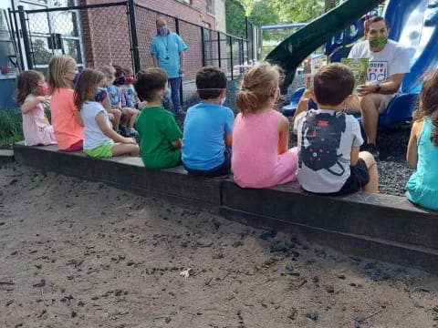 a group of children sitting on the ground