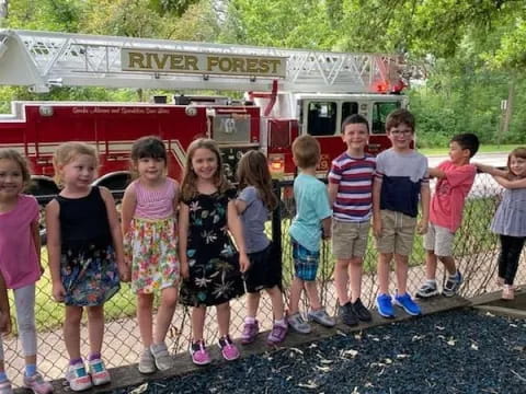 a group of children standing on a sidewalk