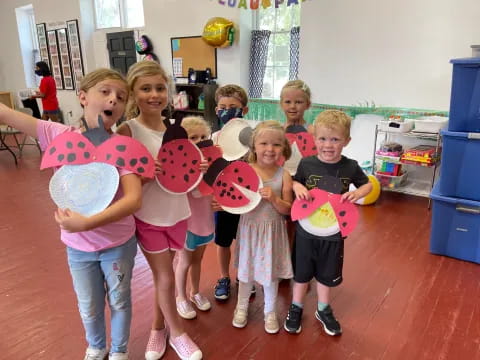 a group of children holding frisbees