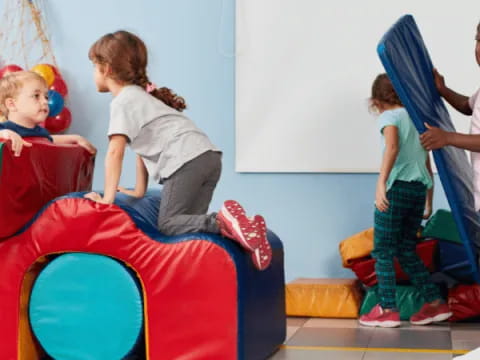 a group of children playing on a playground toy