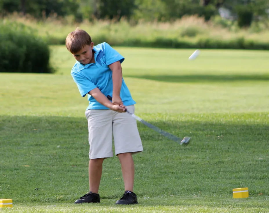 a boy playing golf