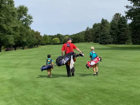 a person and a group of kids playing on a golf course