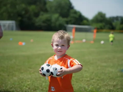 a boy holding a football ball