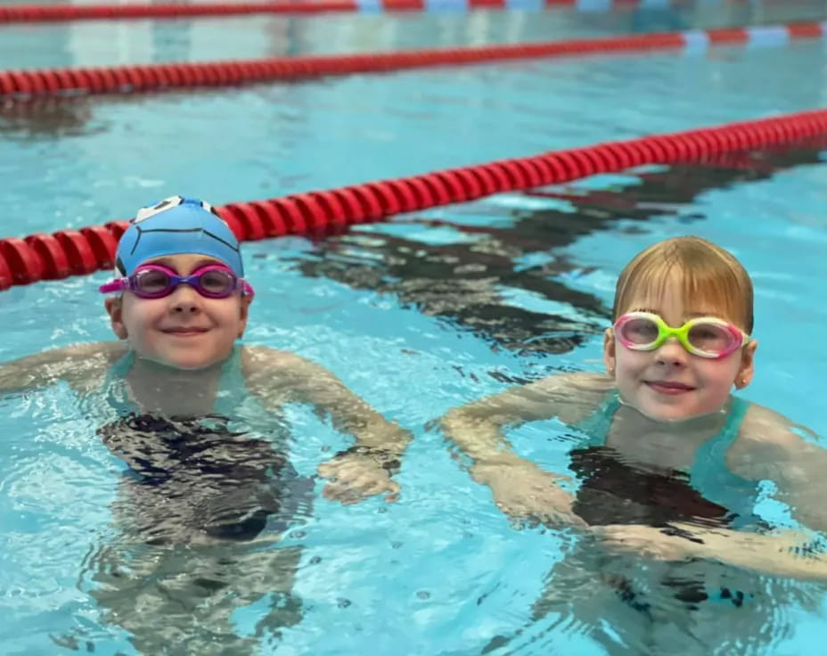 a couple of kids in a pool