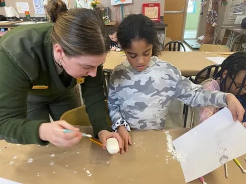 a person and a child sitting at a table