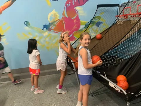 a group of girls holding pumpkins
