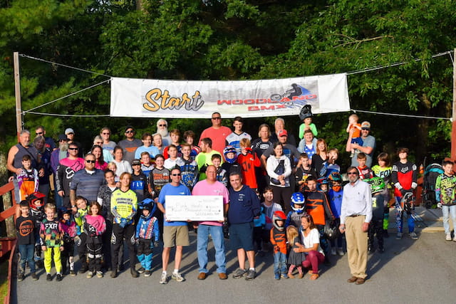 a group of people holding a sign