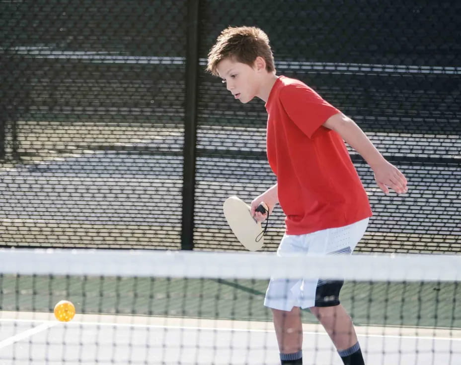 a boy playing tennis
