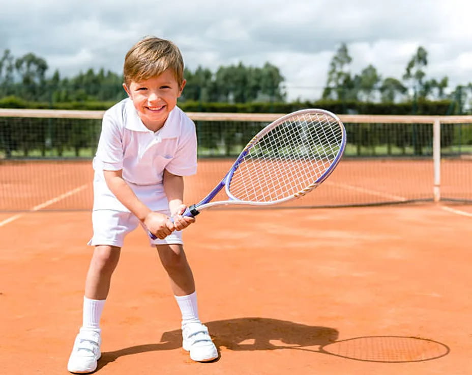 a boy holding a tennis racket